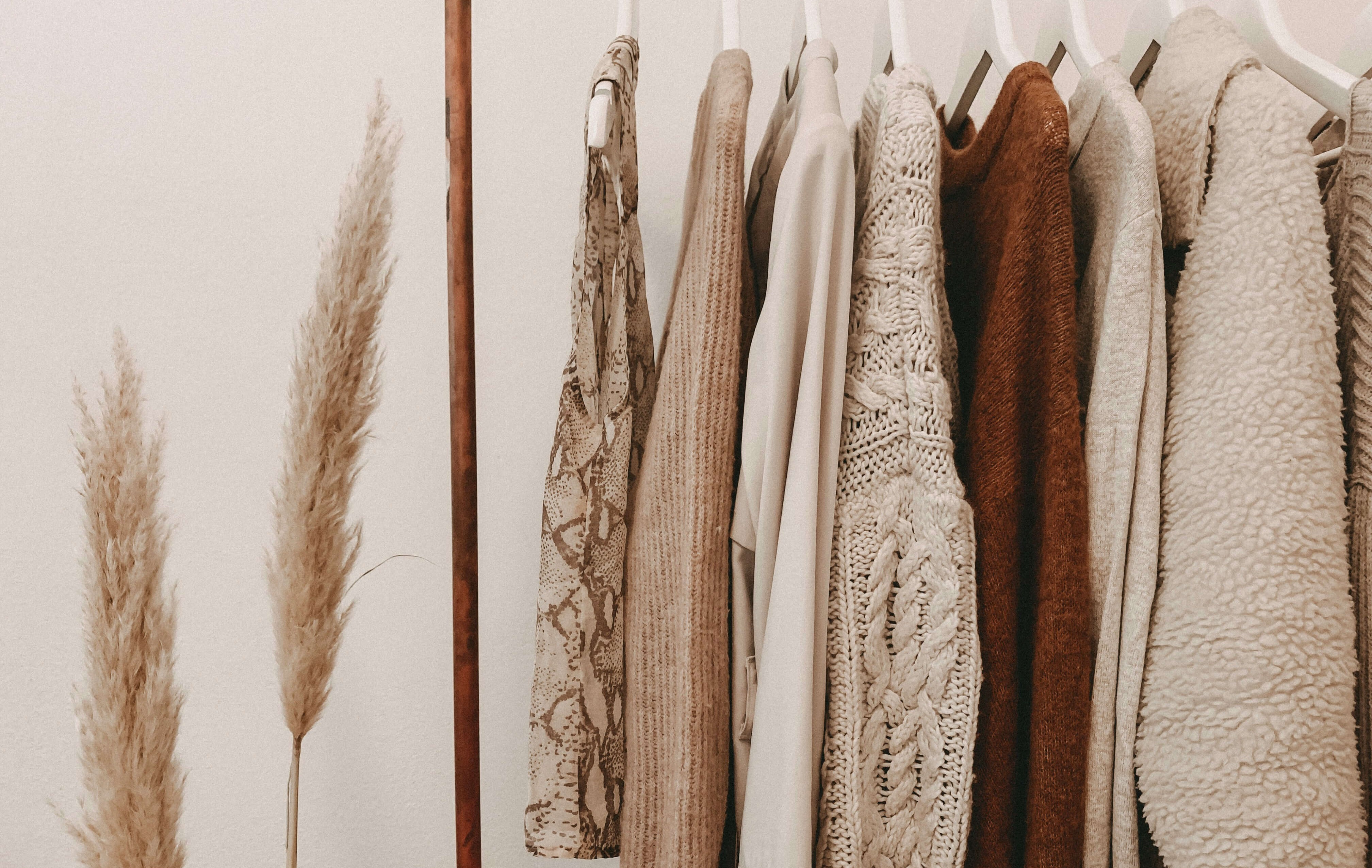 Curated fashion wardrobe with versatile clothing pieces on a rack